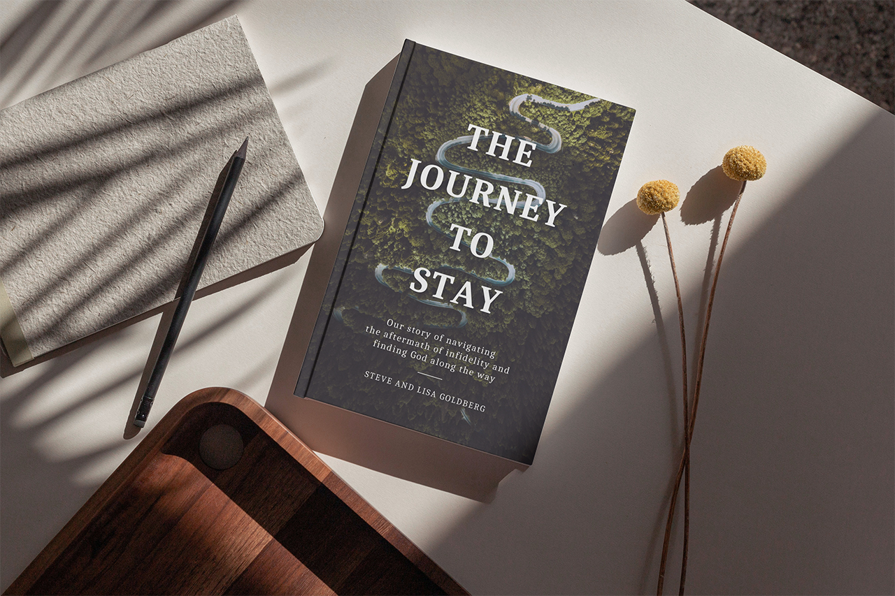 The Journey to Stay book on a desk with shadows